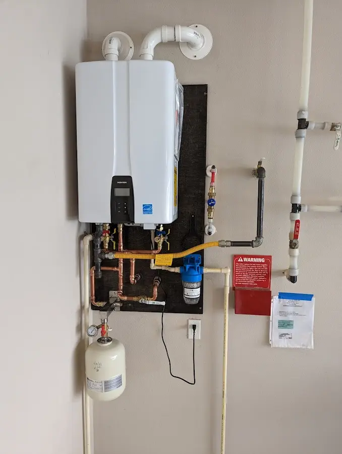 Professional plumber installing copper piping in a Palm Desert home